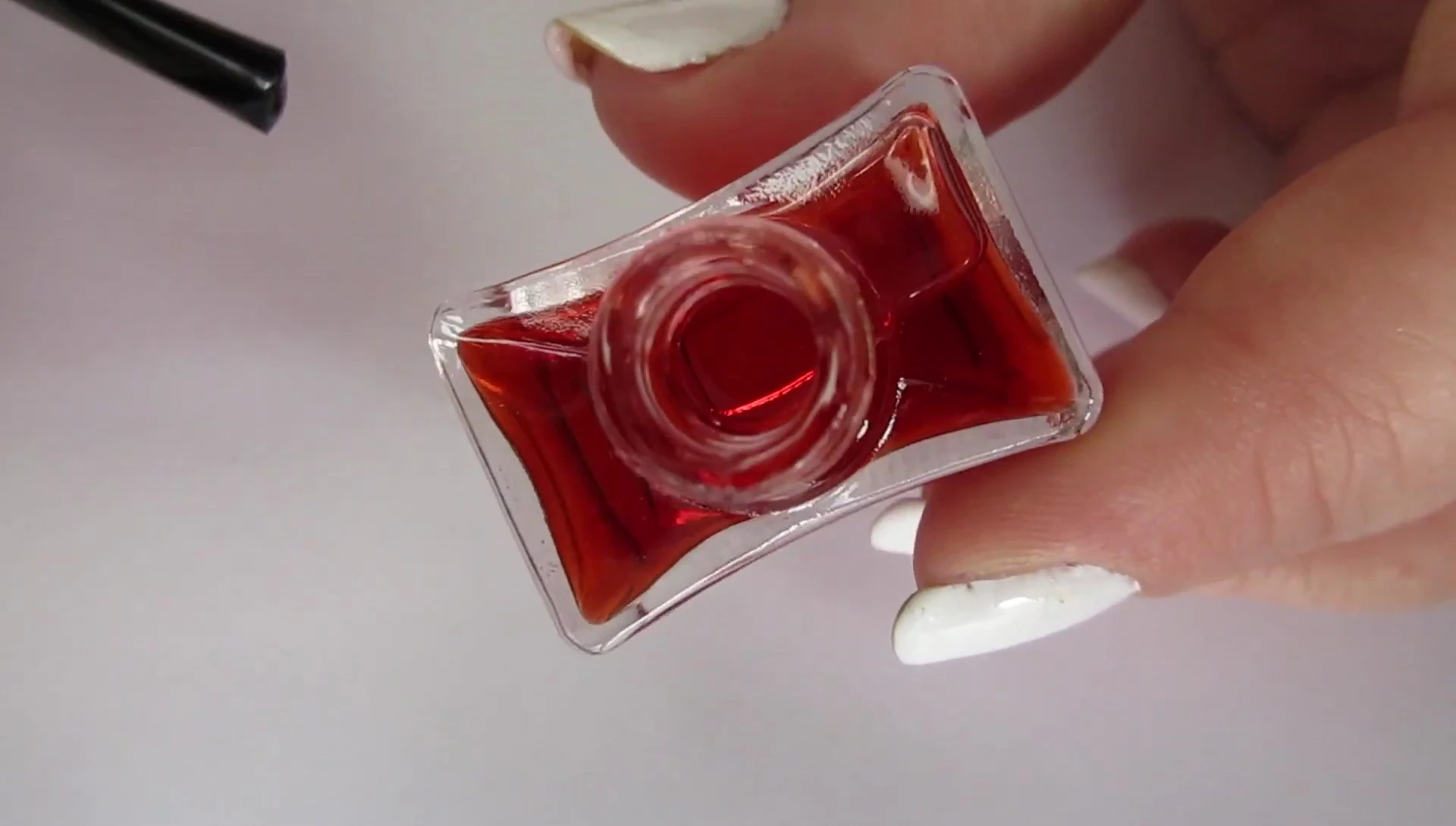 Close up of the sheer pink watercolor nail polish being applied.