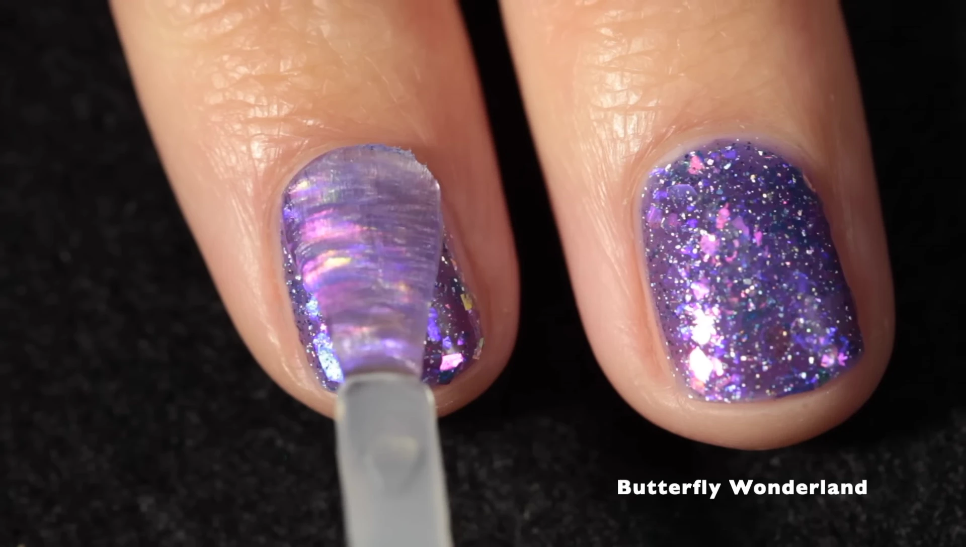 Butterfly Wonderland nail polish on a hand with top coat