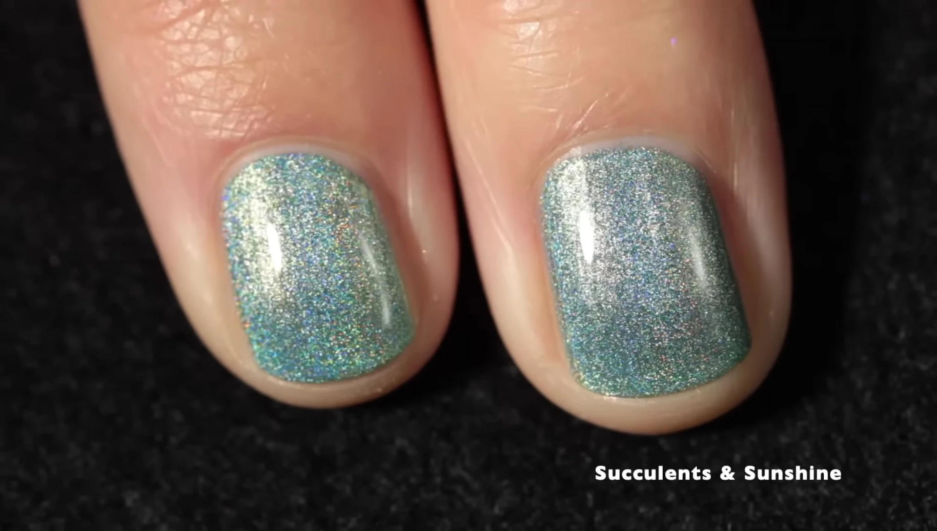 Succulents and Sunshine nail polish on a hand with top coat