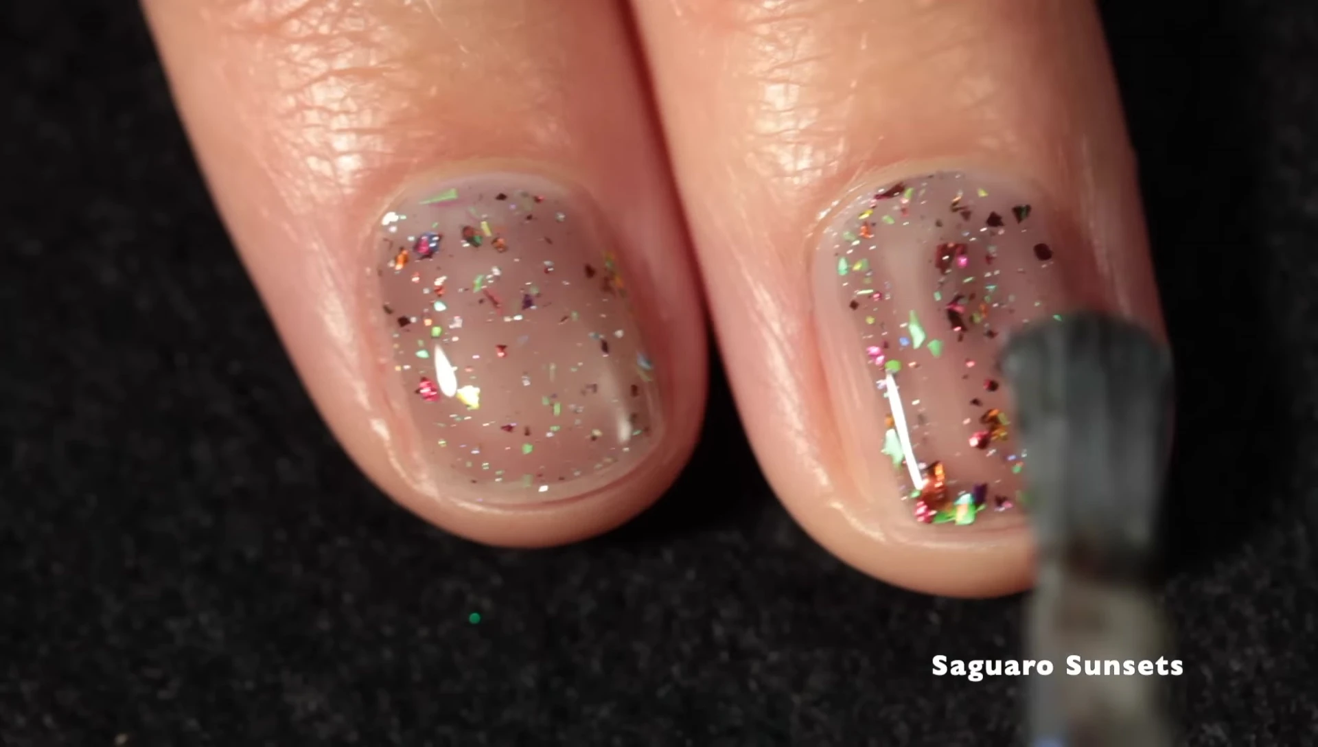 Close-up shot of Sarro Sunset nail polish on a hand