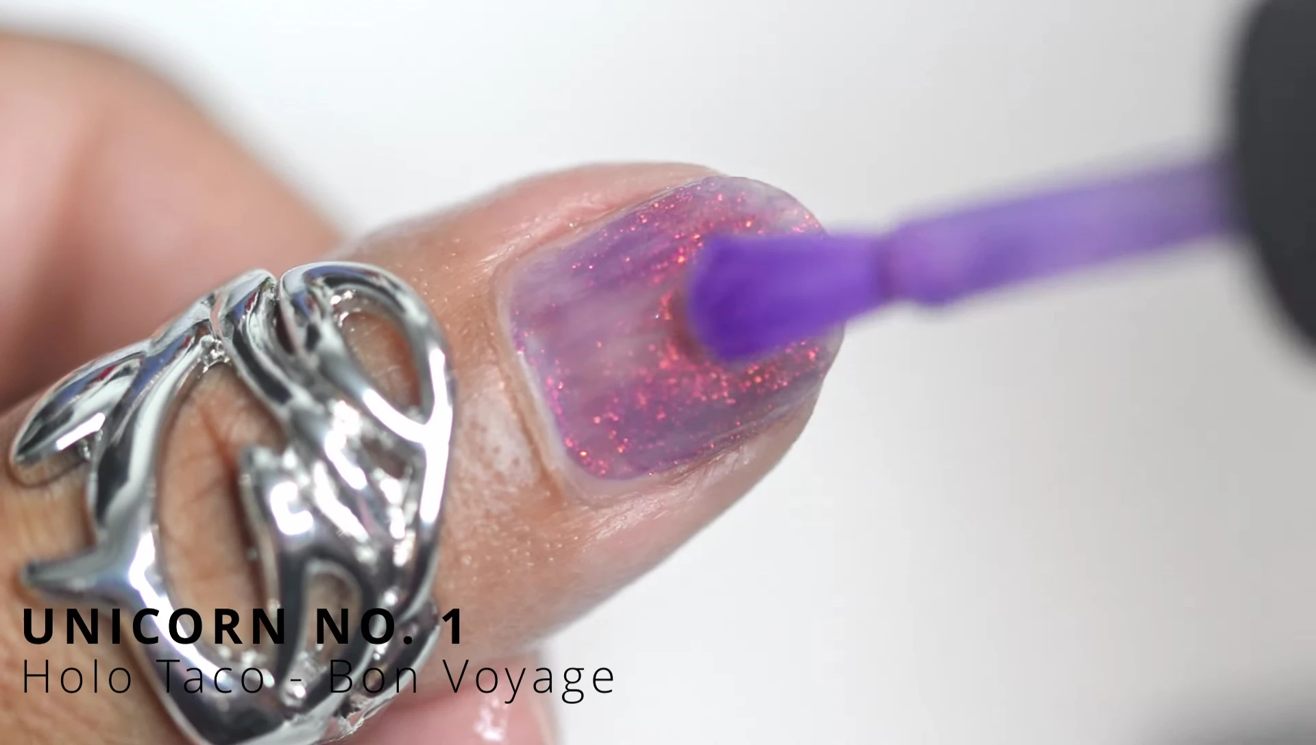 Hand model showcasing the Unicorn Number One polish on nails