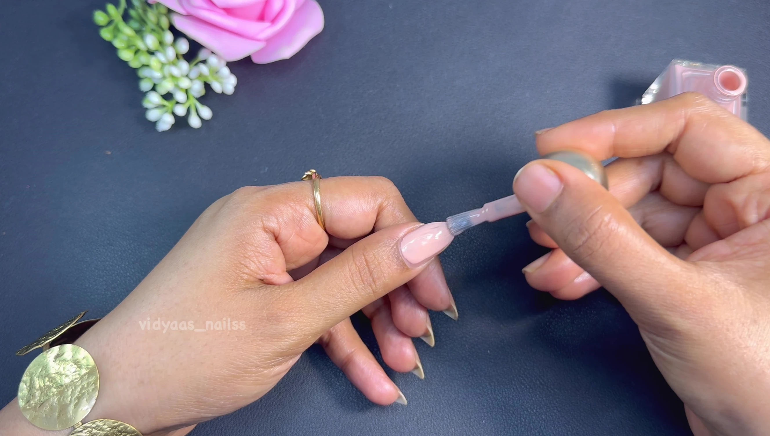 Close-up swatch of Milk Tea nail polish on a fingernail.