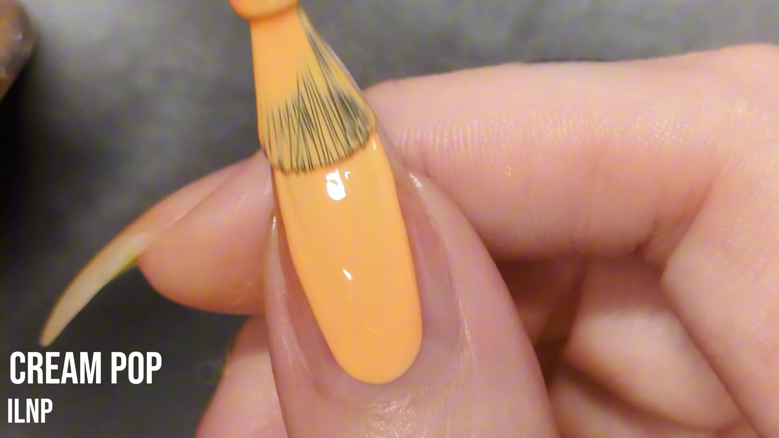 Close-up of Cream Pop nail polish on the model's nail