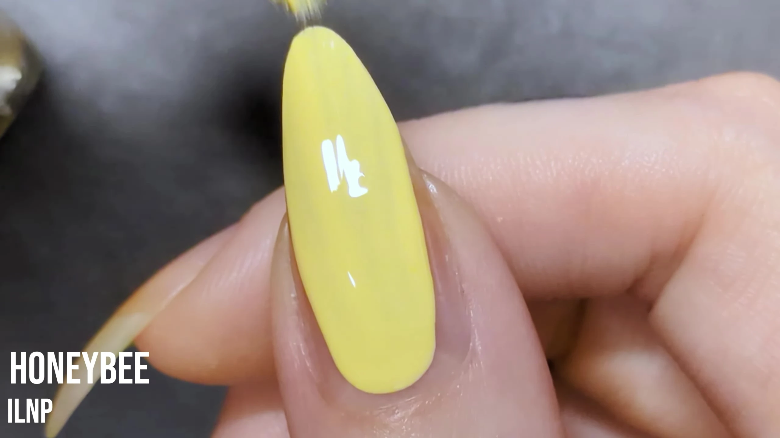 Close-up of Honeybee nail polish on the model's nail