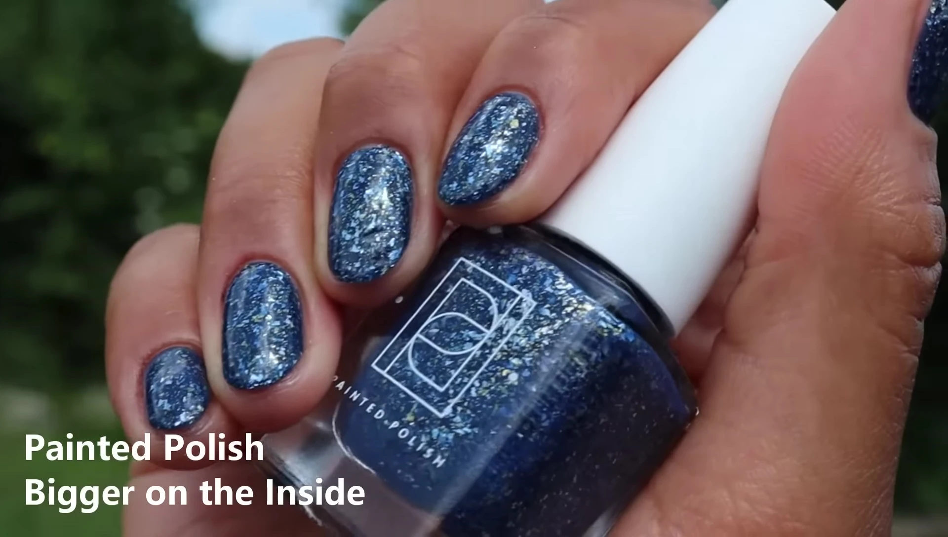 Hand swatch of Bigger on the Inside in two coats with glossy top coat, outdoors.