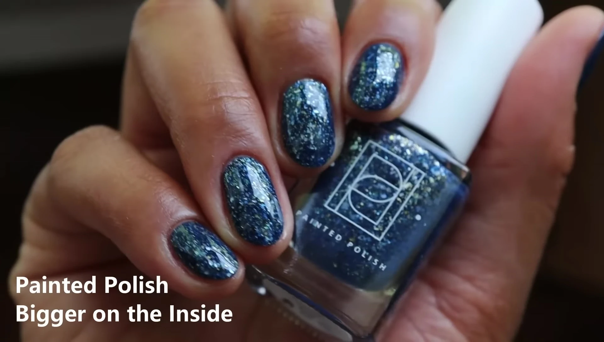 Hand swatch of Bigger on the Inside in two coats with glossy top coat, indoors.