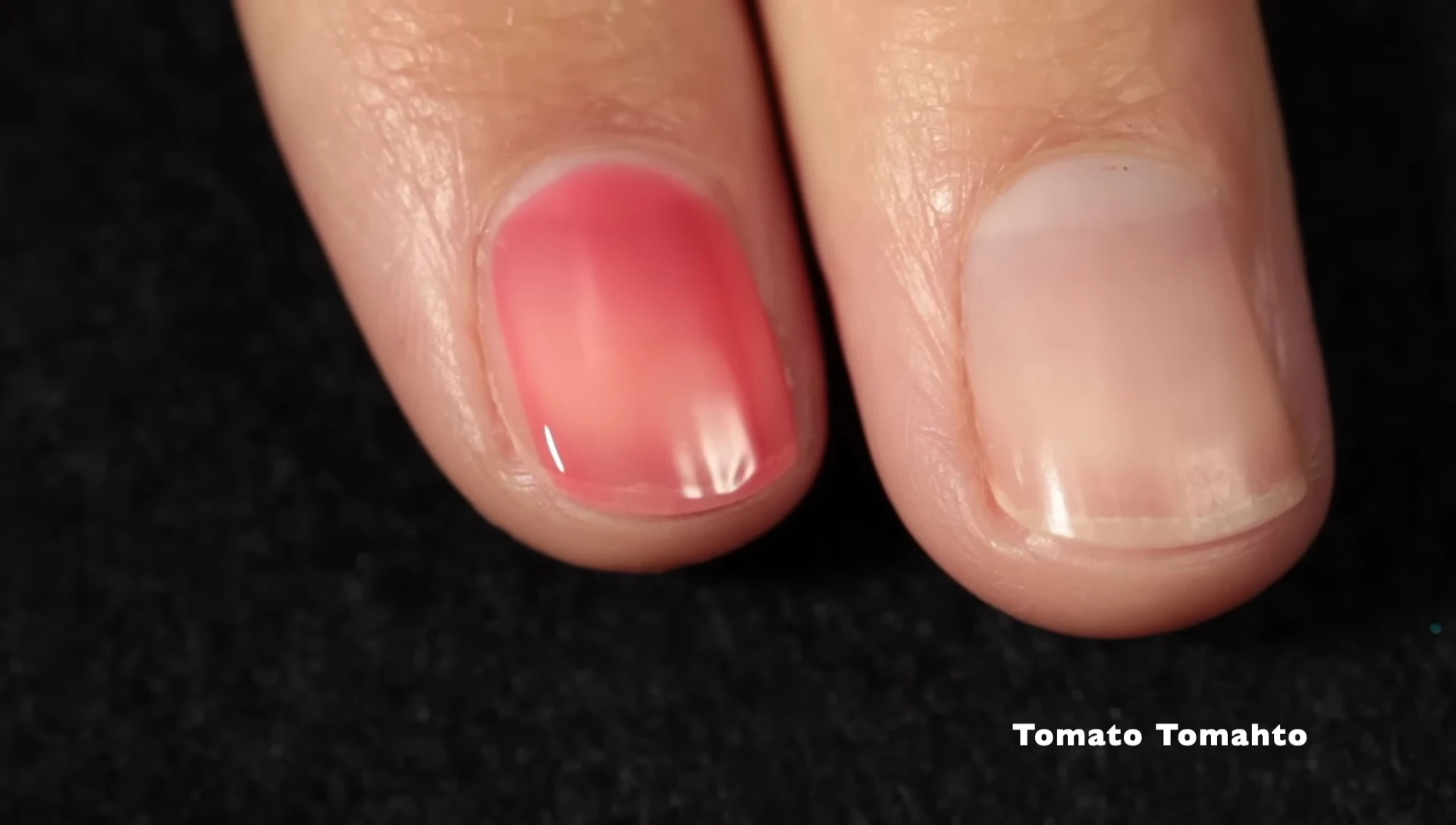 Close-up shot of 'Tomato Tomato' nail polish on nails